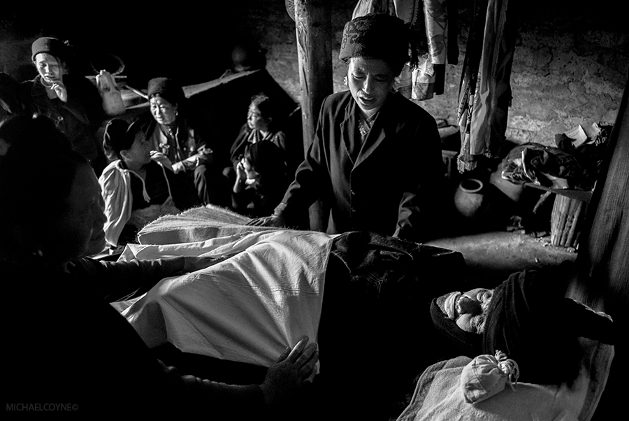 Yi ethnic minority women mourning the death of an elderly man. Zhaojue, Sichuan, China