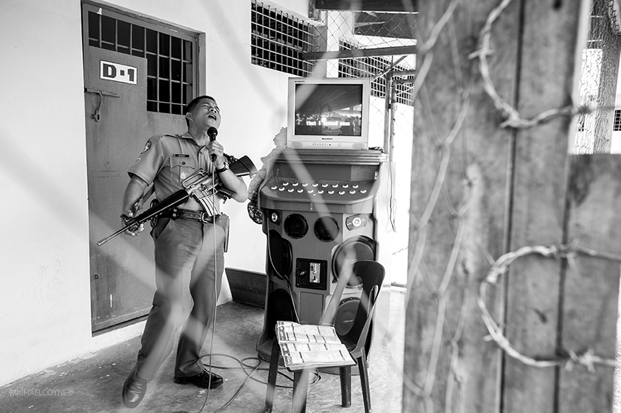 Prison guard performing karaoke. Malaybalay, Mindanao, Philippines