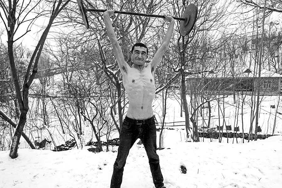 Villager exercising in the snow. Nurata mountains, Asraf, Uzbekistan